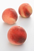 Three white-fleshed peaches
