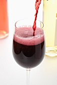 Red Wine Pouring into a Glass From Bottle