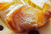 Apple strudel with vanilla sauce (close-up)