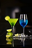 Two cocktails made with champagne, Blue Curacao and limes