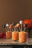Three Candy Corn Filled Containers with Halloween Cake Pops