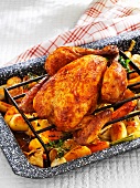 Roast chicken on a bed of oven-roasted vegetables
