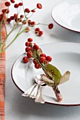 Place setting with name tag made from rosehips and leaves