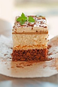 A slice of chocolate and vanilla layer cake