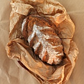 A loaf of bread on brown paper