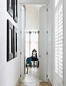 View along hallway to antique dressing table behind blue chair