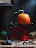 An orange pumpkin on an old pair of scales
