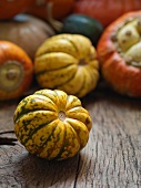 Various pumpkins on a wooden surface