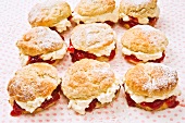 Nine scones with raspberry jam and cream