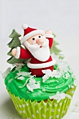A cupcake decorated with a Father Christmas figure