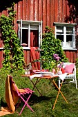 Set garden table in front of wooden cabin