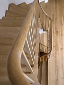 View from above into a modern, simple, oak stairway (Four Oaks Brick House in the Country)