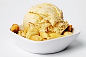 A dish of peanut butter ice cream with roasted peanuts