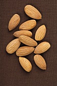 Almonds on a brown surface