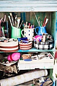 Assorted sewing and craft supplies in a old wooden cupboard
