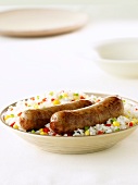 Sausages on a bed of vegetable rice