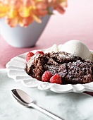 Baked Chocolate Pudding with Powdered Sugar, Ice Cream and Raspberries