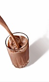 Chocolate Milk Pouring into a Glass; White Background