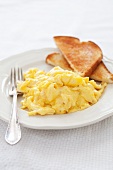 Scrambled Eggs and Toast on a Plate with a Fork