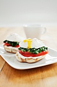 Open Faced Poached Egg Sandwiches on a White Dish