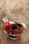 Berries in a Glass Bowl with Mint and a Spoon