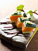 Salmon cubes with cucumber and beetroot leaves