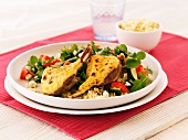 Gratinated lamb chops with a mixed leaf salad, courgettes, tomatoes and couscous