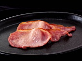 Rashers of bacon in a pan