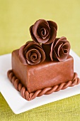A cake decorated with chocolate roses