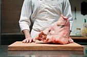 Butcher with head of pig
