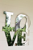 The word 'Love' in mirrored letters as well decoration