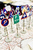 Vintage toys - miniature traffic signs standing on map