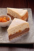 Two slices of cheesecake with apricots