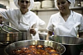 Chefs steeping tomatoes in hot water