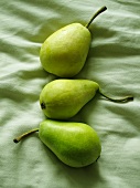 Three pears on a green cloth