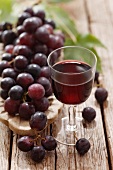 Glass of red wine and red grapes