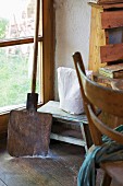 Wooden peel & wooden stool in corner of kitchen