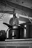 Old pans on cooker (black and white photo)