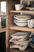 Crockery in wooden dresser with open door