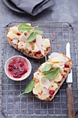 Grilled slices of bread topped with pears and cranberries