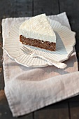 A piece of poppy seed cake topped with coconut mousse