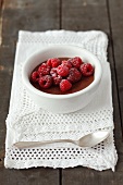 Chocolate pudding topped with raspberries