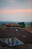 Sunset view across roofs of a small French village in the Gers region