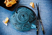 Blue Asian Tea Pot with Chopsticks and Fortune Cookies
