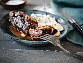 Braised Ribs with Mashed Potatoes; Fork Piercing the Meat