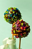 Cake pops decorated with dinosaur sprinkles