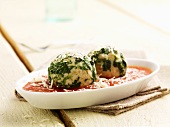 Spinach dumplings in tomato sauce