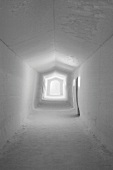 Corridor with small windows in building made of ice