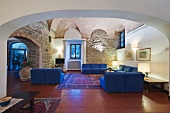 Hotel lobby in historical building with terracotta tiles and modern seating with blue upholstery