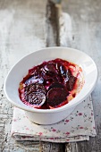 Beetroot gratin in a white bowl on a light surface